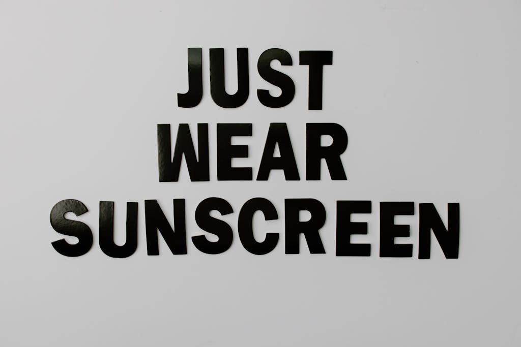 Bold black text saying 'Just Wear Sunscreen' on a white background.
