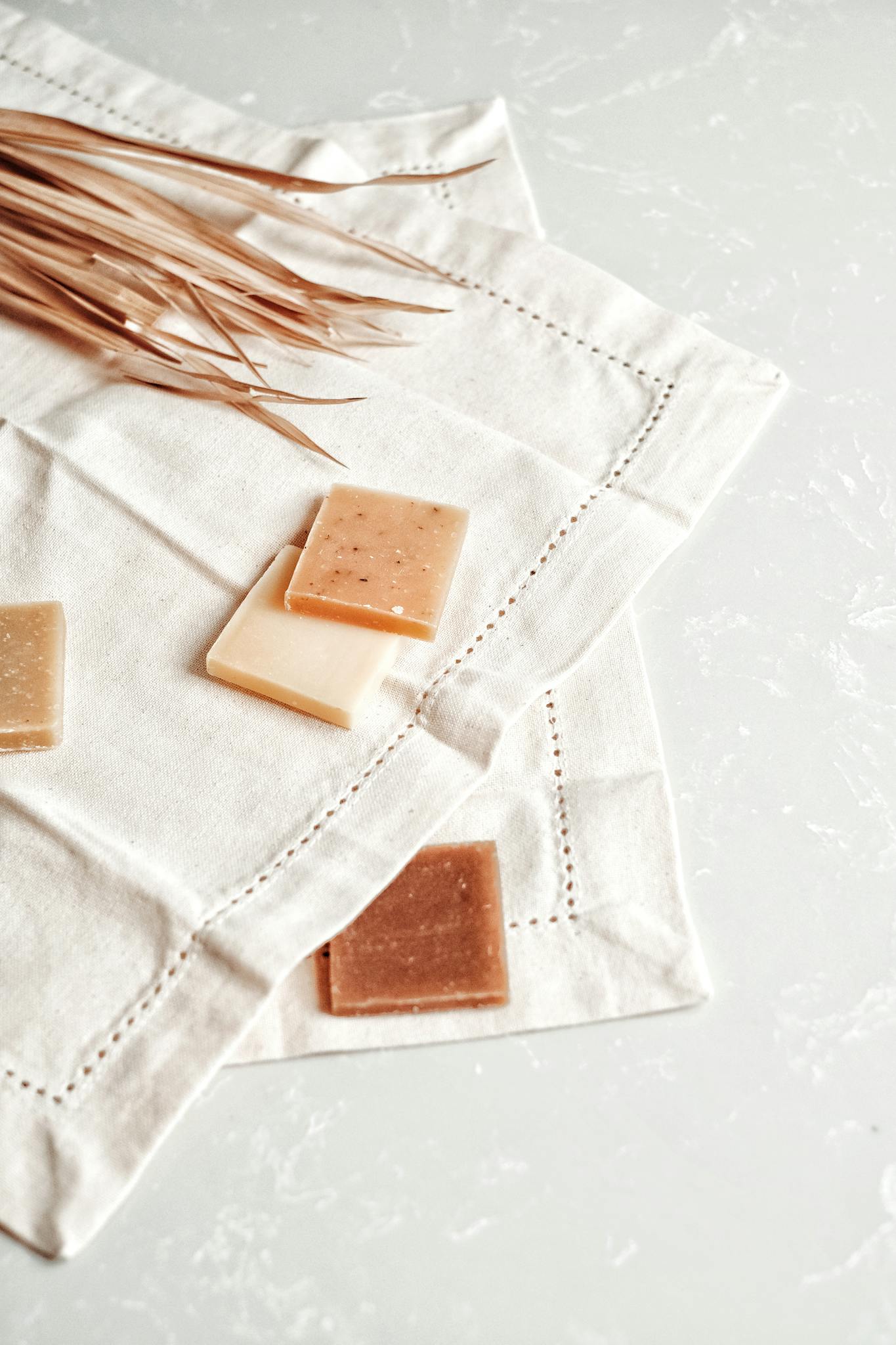 Eco-friendly soap bars placed on a linen cloth, embodying minimalistic and organic lifestyle.